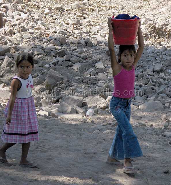 cora_costume_001.JPG - Litlle kids carrying laundry back from the river