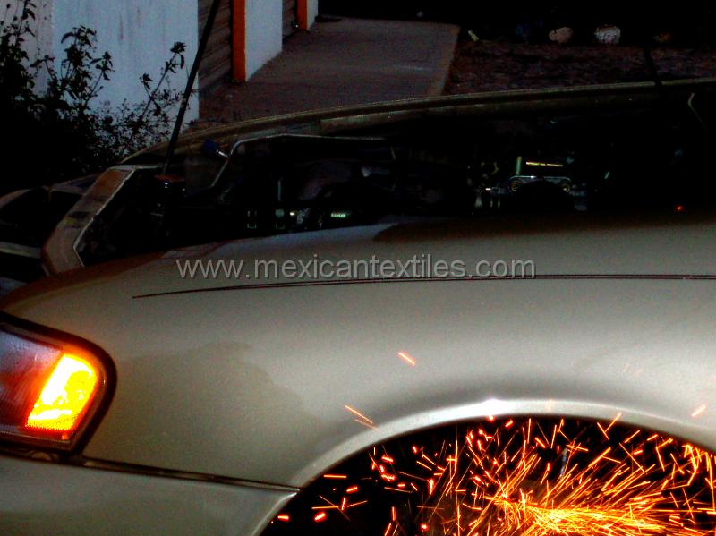 P1300012.JPG - My steel plate which guarded the underside of my car was ripped off on the road into San Andres. Here the car is in Acaponeta getting the Shield replaced. Unfortunatly it only lasted about 1 hour on the road into the Sierra Nayar.