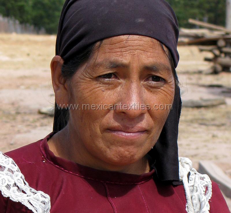 tepehuano_woman_03.jpg - Documentation of tepehuano indigenous textiles from Huajicori, Nayarit, Mexico. Many tepehuanos from the state of Durango walk from to Acaponeta to work in the fields harvesting beans and other food. This woman was walking there and we took her photo in Murallitos. The road actually ends here and is by foot into the canyon and beyond.