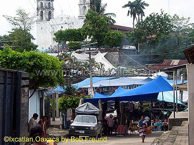 Ixcatlanmarket.jpg - The street scene with a small market, in the foreground a woman in costume.