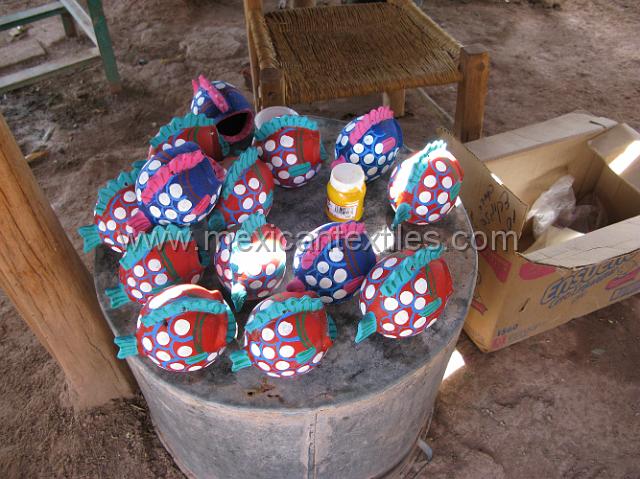 ahuelican_nahuatl25.JPG - Clay fish being painted and drying in the shade. The Rio Balsas region is known for its crafts and many villages participate and certain villages are the center of the trade. Rough road to San Agustin Oapan , a traditional center< leads me to believe that some work is sub contracte from Oapan to Ahuelican.