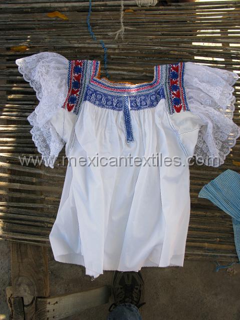 Analco_embroidery04.JPG - This blouse is worn in at least three villages Analco, Oapan, and Tula del Rio. It is a smocked pepinada type embroidery and has  machine embroidery on the shoulder and around the neck, the sleeves are decorated with lace. I have only seen white cotton used to for the body of the blouse.