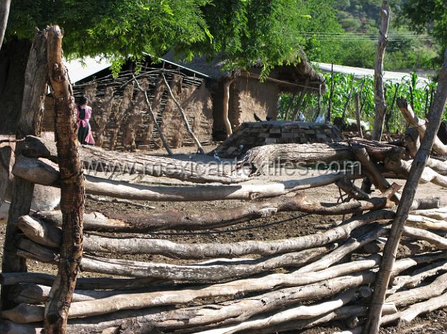 nahuatl_analco43.JPG - Rustic wood fence with traditional home in the background