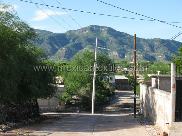 nahuatl_analco80.JPG - Newly paved streets , in the background are the cliff that form a rather large turn in the river. For years the road that passed that curve was the most dangerous part of the trip. It is now paved but there are still landslide because it is so new.(2009)