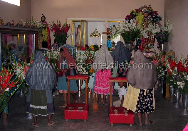 Tetelcingo_6.JPG - Inside the chapel, this photo was taken a week before a festival in Feb 2005. The interesting thing here is we are able to see the traditional skirt made from store bought material but with a lace adornment and the size of the apron. The rebosos is ever present and used for so many things. This region is very hot and the rebosos is used to cover the head when walking in the open.