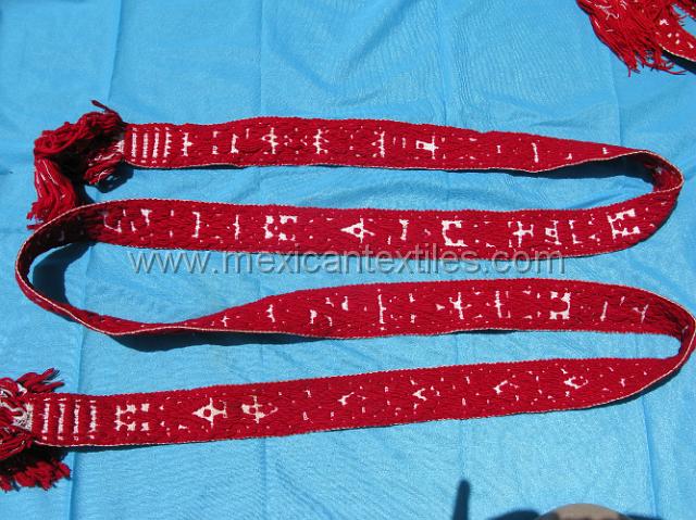 nahuatl_hueytentan_02.JPG - These red belts are the traditional onesworn by the oldeest generatio, they are woven on a backstrap loom.n. I saw a nymber of different widths. The only woman I encountered wearing traditional costume had a thick and wider version, she also had this belt and told me a relative had woven it in the town.