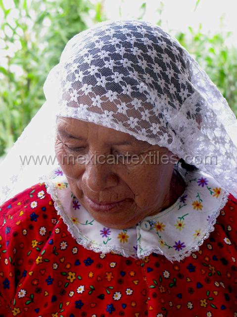 nahuatl.JPG - A close up of the way the quechquemitl is worn on the head and the traditional blouse of the region made from store bought material.