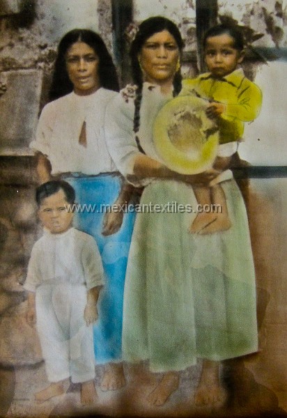 Otomi_Ixtenco_86.jpg - A old photo I found in the home of the town historian Augustin Rancheria. This is his mother holding him with the grandmother to the left. The Ixtenco blouse was worn under the overblouse as is the custom in many towns.
