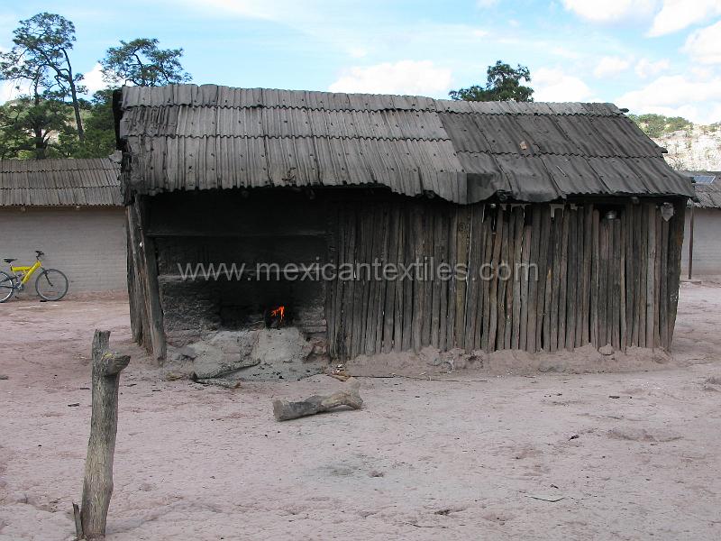 muralita_town_05.JPG - Documentation of tepehuano indigenous textiles from Huajicori, Nayarit, Mexico. This image shwos how the fireplace is heated from the outside.