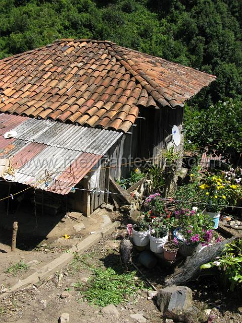 town_tlaquimpa_07.JPG - Looking down on the roof of a home in town.